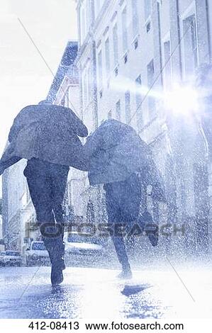 Businessmen with umbrellas running in rainy street View Large Photo Image Stock Image - Businessmen with umbrellas running in rainy street. Fotosearch