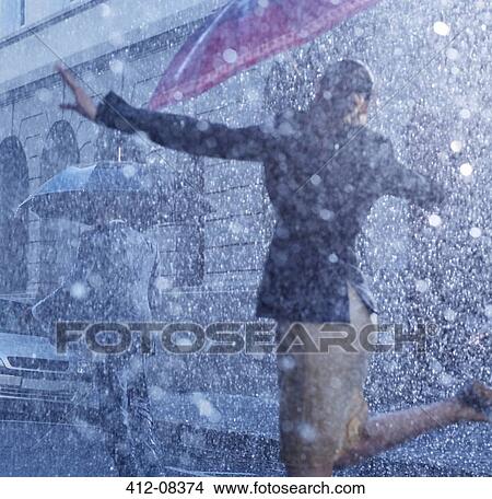 Picture - Businesswoman dancing in rain. Fotosearch
