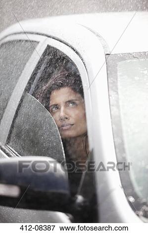 Businesswoman in car looking up at rain View Large Photo Image Stock Photo - Businesswoman in car looking up at rain. Fotosearch