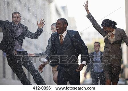 Enthusiastic business people running in rainy street View Large Photo Image Stock Image - Enthusiastic business people running in rainy street. Fotosearch