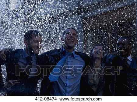 Picture - Enthusiastic businessmen in rain. Fotosearch