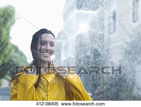 Enthusiastic woman standing in rain View Large Photo Image Stock Photography - Enthusiastic woman standing in rain. Fotosearch