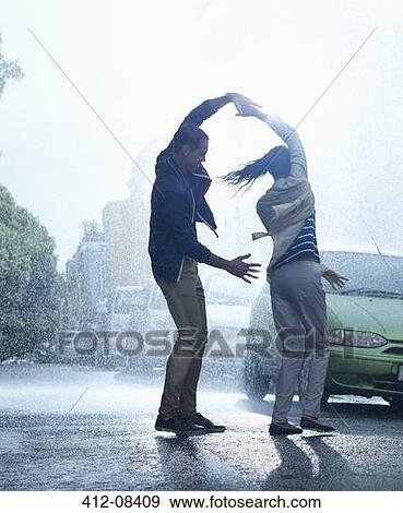 Stock Photo - Happy couple dancing in rain. Fotosearch