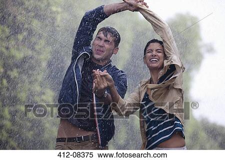 Happy couple dancing in rain View Large Photo Image Stock Photography - Happy couple dancing in rain. Fotosearch