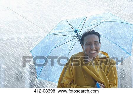 Happy woman under umbrella in rain View Large Photo Image Stock Photo - Happy woman under umbrella in rain. Fotosearch