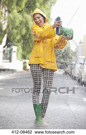 Portrait of enthusiastic woman emptying boot in rain View Large Photo Image Stock Image - Portrait of enthusiastic woman emptying boot in rain. Fotosearch