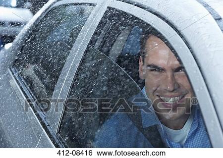 Portrait of smiling man in car View Large Photo Image Stock Photograph - Portrait of smiling man in car. Fotosearch