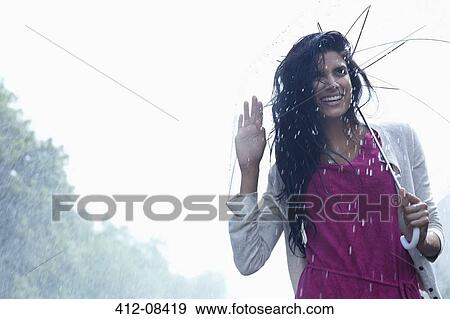 Portrait of smiling woman under umbrella in rain View Large Photo Image Stock Photo - Portrait of smiling woman under umbrella in rain. Fotosearch