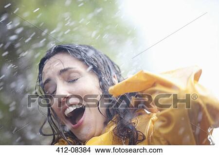 Picture - Rain falling on surprised woman. Fotosearch