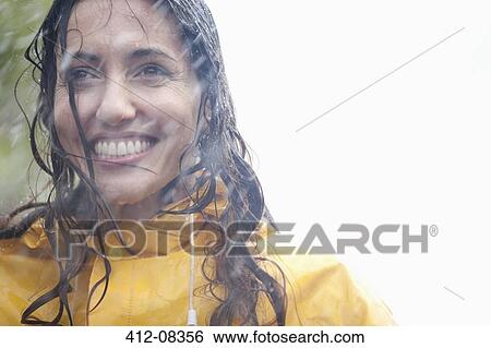 Stock Photograph - Smiling woman in rain. Fotosearch