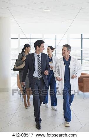 Stock Photo - Doctors and administrators talking in hospital. Fotosearch