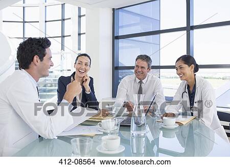 Doctors and business people talking in meeting View Large Photo Image Picture - Doctors and business people talking in meeting. Fotosearch