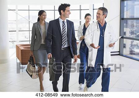 Doctors and business people talking in hospital View Large Photo Image Stock Photo - Doctors and business people talking in hospital. Fotosearch