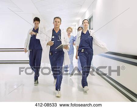 Doctors rushing down hospital corridor View Large Photo Image Stock Image - Doctors rushing down hospital corridor. Fotosearch