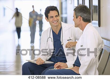 Stock Photo - Doctors talking in hospital corridor. Fotosearch