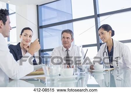 Stock Photography - Doctors talking in meeting. Fotosearch