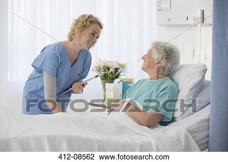 Nurse and aging patient talking in hospital room View Large Photo Image Stock Image - Nurse and aging patient talking in hospital room. Fotosearch
