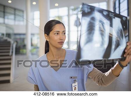 Nurse examining chest x-rays in hospital View Large Photo Image Stock Photograph - Nurse examining chest x-rays in hospital. Fotosearch