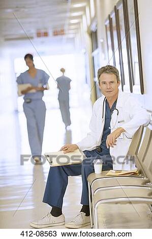 Stock Image - Portrait of serious doctor in hospital corridor. Fotosearch
