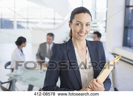 Portrait of smiling businesswoman in meeting with doctors View Large Photo Image Stock Photo - Portrait of smiling businesswoman in meeting with doctors. Fotosearch