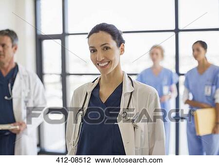 Portrait of smiling doctor in hospital View Large Photo Image Stock Image - Portrait of smiling doctor in hospital. Fotosearch