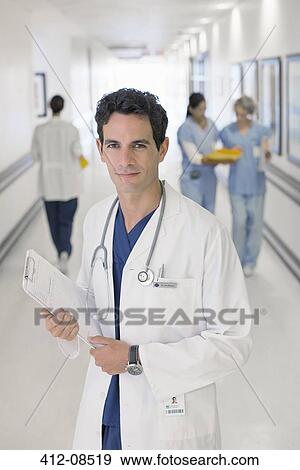 Portrait of smiling doctor in hospital View Large Photo Image Stock Photo - Portrait of smiling doctor in hospital. Fotosearch
