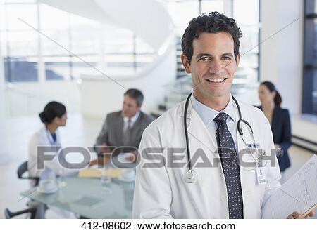 Portrait of smiling doctor in meeting View Large Photo Image Stock Image - Portrait of smiling doctor in meeting. Fotosearch