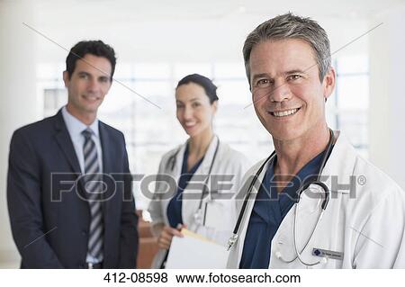 Portrait of smiling doctors and businessman View Large Photo Image Stock Photo - Portrait of smiling doctors and businessman. Fotosearch