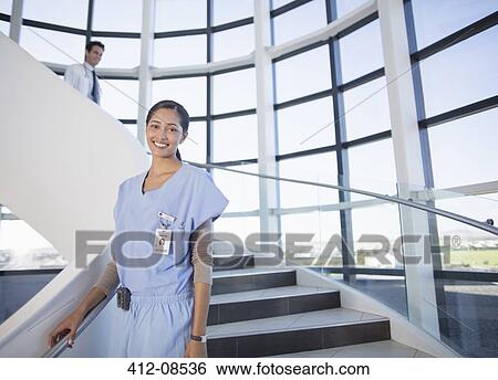 Portrait of smiling nurse on stairs View Large Photo Image Stock Photograph - Portrait of smiling nurse on stairs. Fotosearch