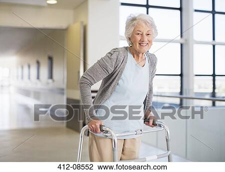 Senior patient using walker in hospital View Large Photo Image Stock Image - Senior patient using walker in hospital. Fotosearch