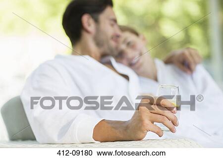 Couple in bathrobes hugging on patio View Large Photo Image Stock Image - Couple in bathrobes hugging on patio. Fotosearch