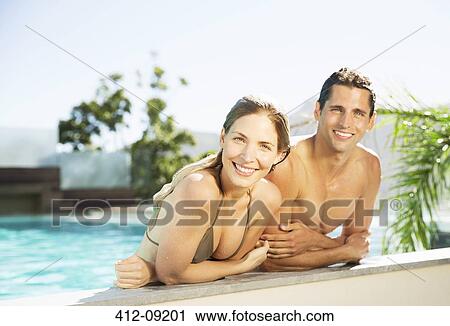 Couple relaxing in swimming pool View Large Photo Image Stock Image - Couple relaxing in swimming pool. Fotosearch