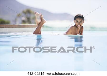Couple relaxing in swimming pool View Large Photo Image Stock Photography - Couple relaxing in swimming pool. Fotosearch
