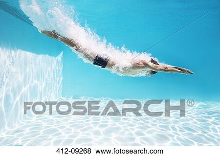 Man diving into swimming pool View Large Photo Image Stock Photo - Man diving into swimming pool. Fotosearch