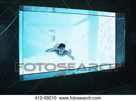 Man looking through window underwater in swimming pool View Large Photo Image Stock Image - Man looking through window underwater in swimming pool. Fotosearch