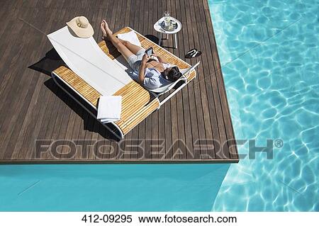 Man Relaxing On Lounge Chair At Poolside Stock Photography 412