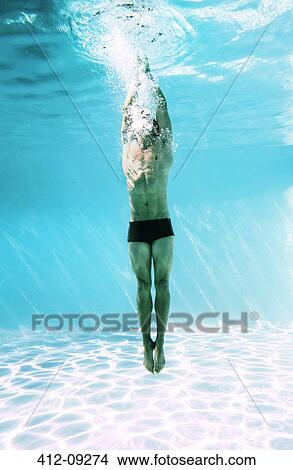 Man underwater in swimming pool View Large Photo Image Picture - Man underwater in swimming pool. Fotosearch