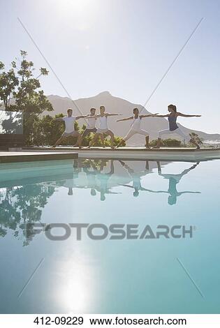 People practicing yoga at poolside View Large Photo Image Stock Photo - People practicing yoga at poolside. Fotosearch