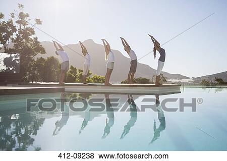 People practicing yoga at poolside View Large Photo Image Stock Photo - People practicing yoga at poolside. Fotosearch