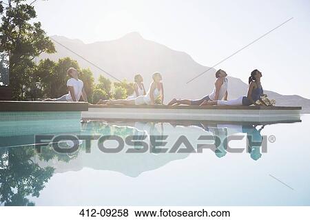 People practicing yoga at poolside View Large Photo Image Stock Photo - People practicing yoga at poolside. Fotosearch