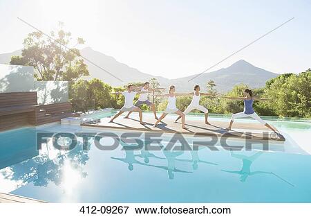 People practicing yoga at poolside View Large Photo Image Stock Photo - People practicing yoga at poolside. Fotosearch
