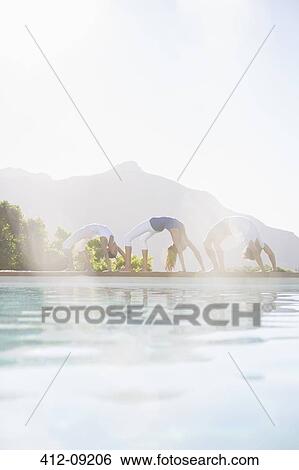 People practicing yoga at poolside View Large Photo Image Stock Photograph - People practicing yoga at poolside. Fotosearch