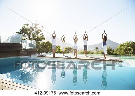 People practicing yoga at poolside View Large Photo Image Stock Photography - People practicing yoga at poolside. Fotosearch