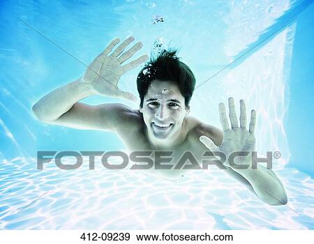 Portrait of man smiling underwater in swimming pool View Large Photo Image Stock Photo - Portrait of man smiling underwater in swimming pool. Fotosearch