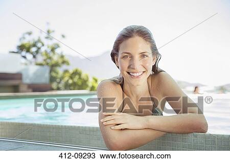 Portrait of smiling woman at the edge of swimming pool View Large Photo Image Stock Image - Portrait of smiling woman at the edge of swimming pool. Fotosearch