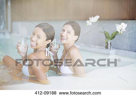 Stock Photo - Portrait of smiling women in spa pool. Fotosearch