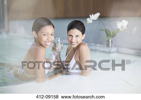 Portrait of smiling women in swimming pool at spa View Large Photo Image Stock Photo - Portrait of smiling women in swimming pool at spa. Fotosearch