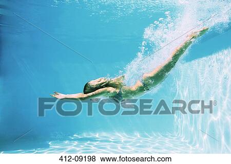 Stock Photo - Woman diving into swimming pool. Fotosearch