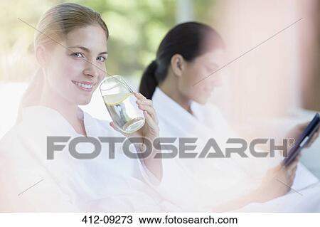 Woman drinking glass of water in spa View Large Photo Image Stock Image - Woman drinking glass of water in spa. Fotosearch