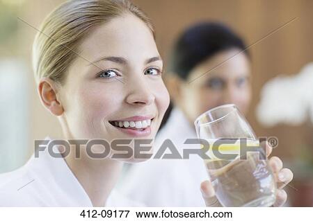 Woman drinking glass of water View Large Photo Image Stock Photo - Woman drinking glass of water. Fotosearch